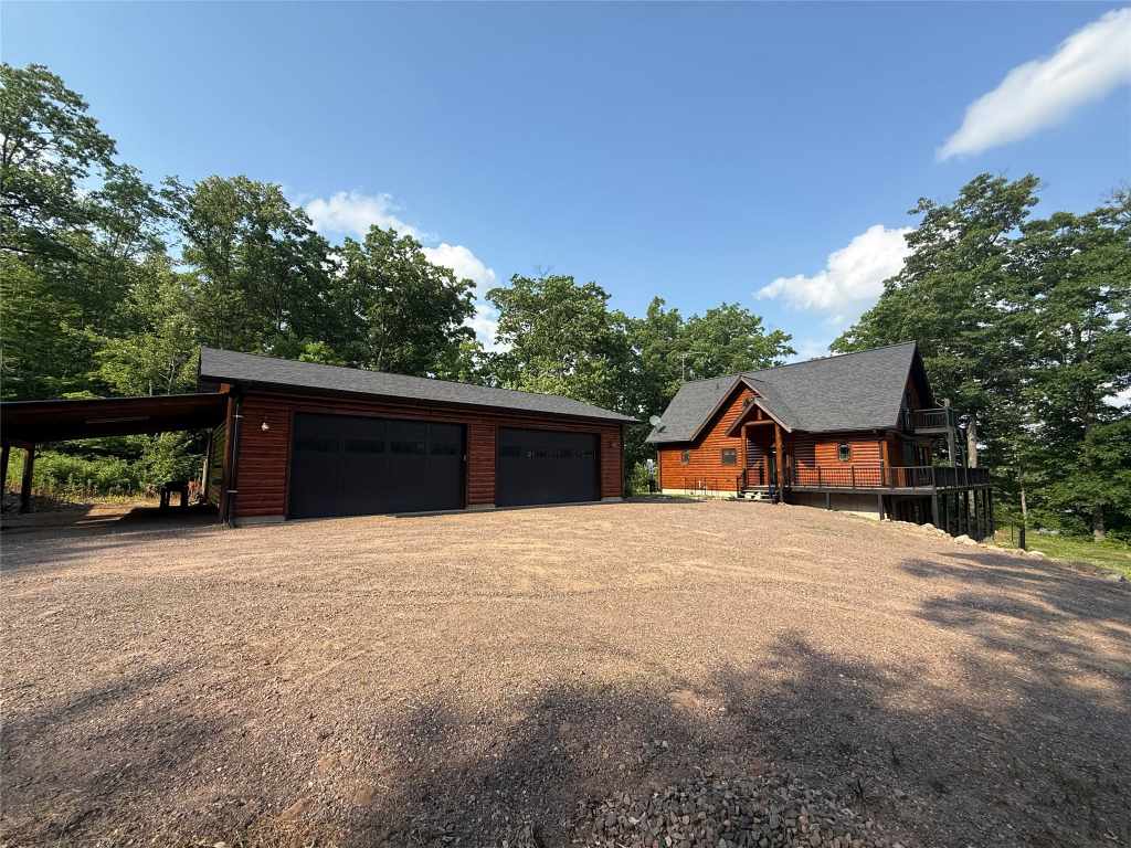 Cabin, garage and large gravel parking area