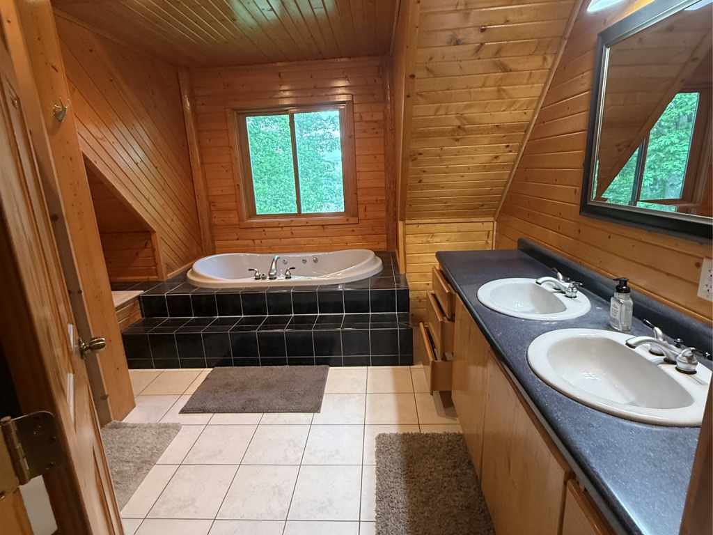 Large wood-paneled bathroom with soaking tub