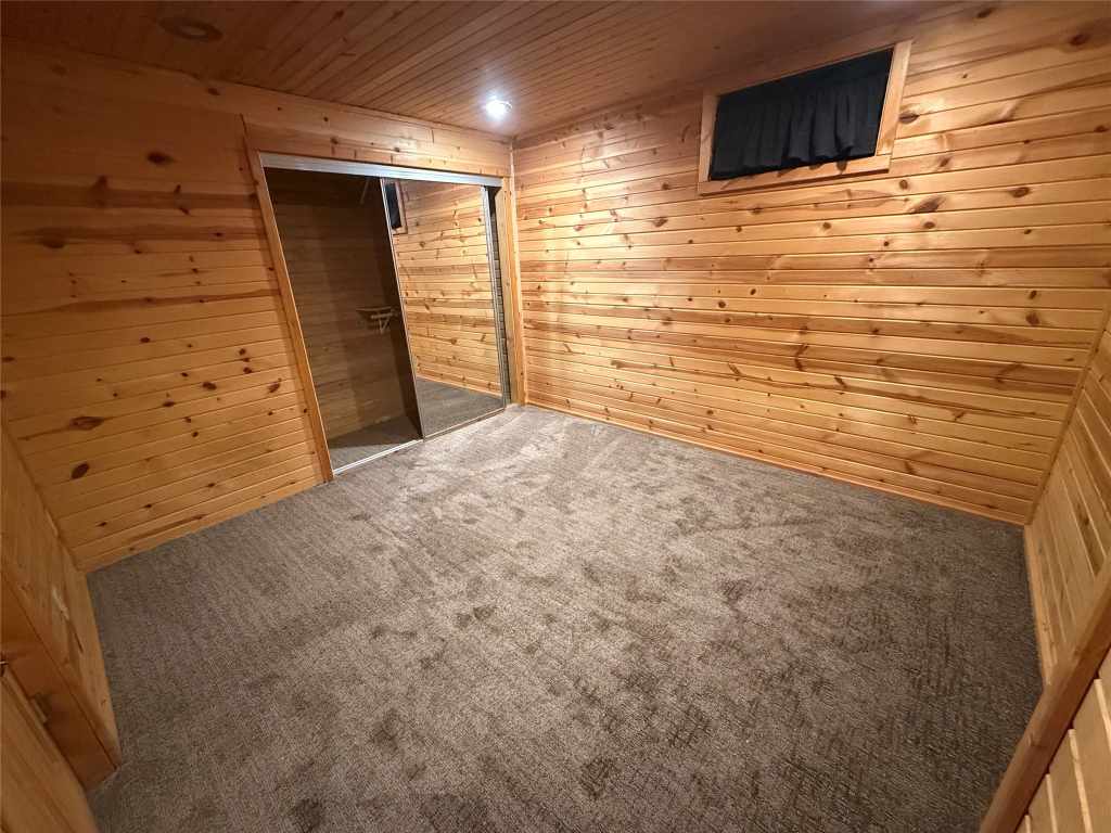Second wood-paneled guest bedroom